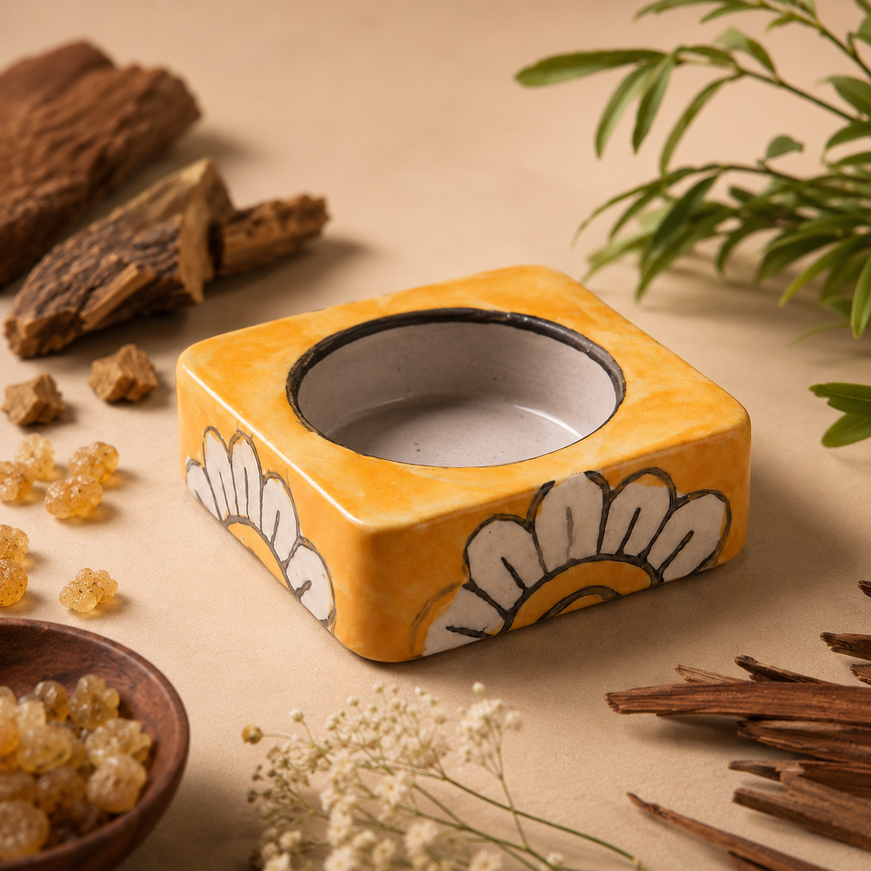 Yellow floral ceramic havan cup stand without cup - top view